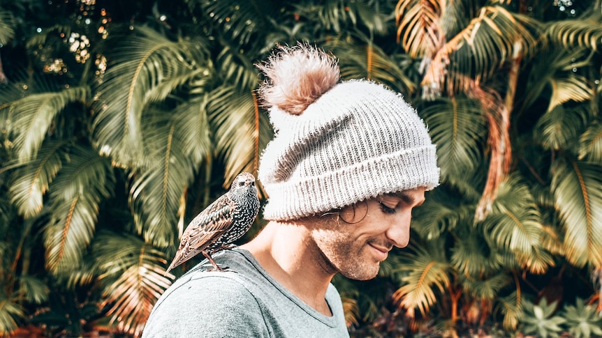 Man with bird on his shoulder