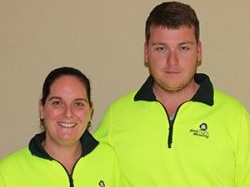 Mara Harvey and Anthony Harvey from Jims Mowing profile shot. They wear high vis.