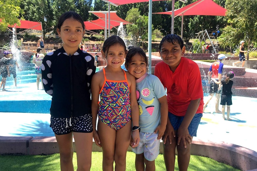 Four children stand together at a water park in Ipswich, west of Brisbane.