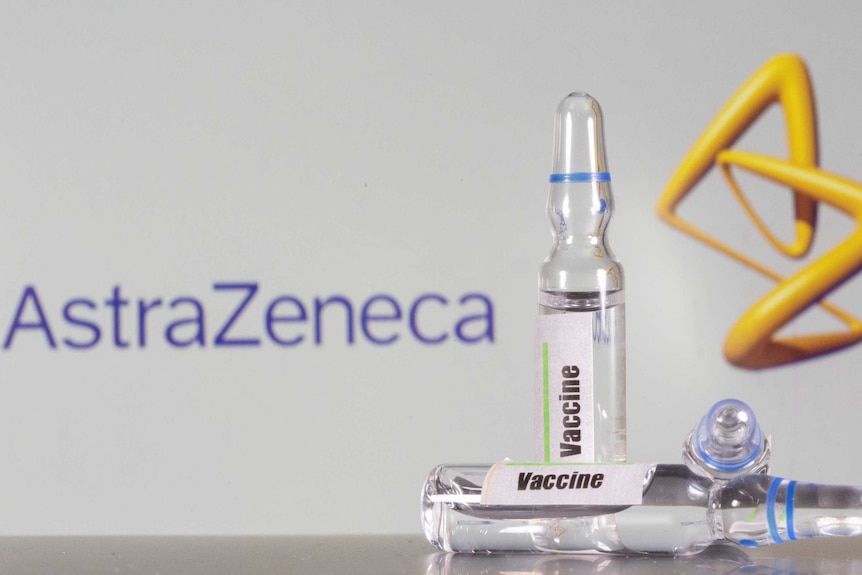A AstraZeneca logo sits behind vials of generic vaccine.