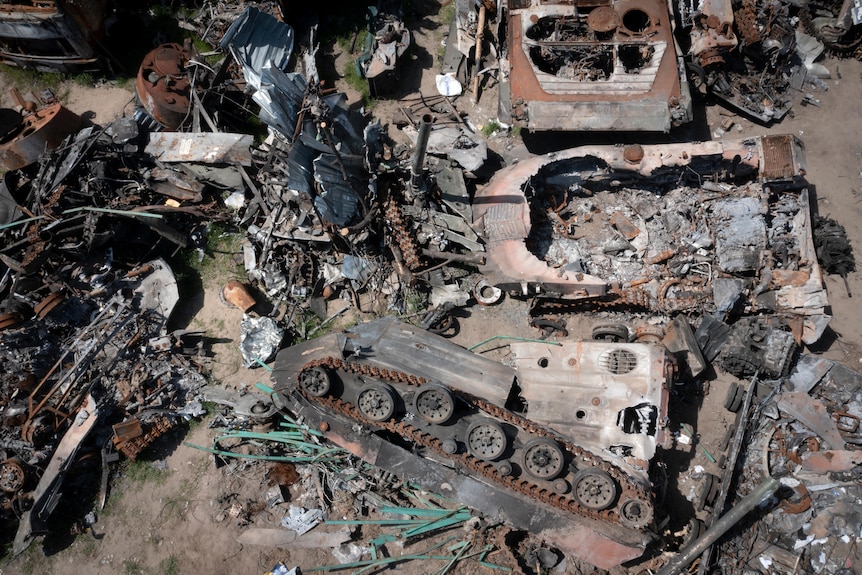 Destroyed Russian military vehicles lie in a garbage dump