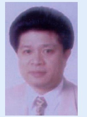 A passport photo of a middle aged chinese man.