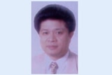 A passport photo of a middle aged chinese man.