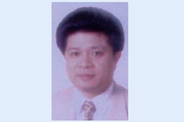 A passport photo of a middle aged chinese man.