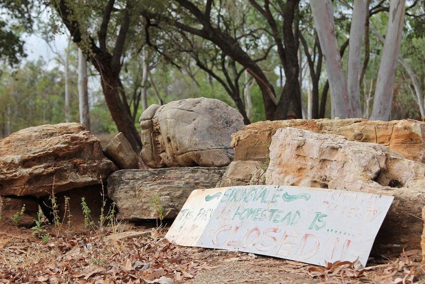 A photo of a sign leaning against some rocks that says Springvale Homestead is closed.