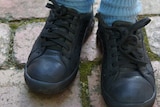A student wearing school shoes.