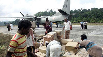 Rescue workers move aid packages in India
