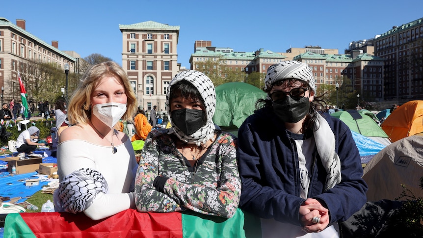 Three protesters in masks 