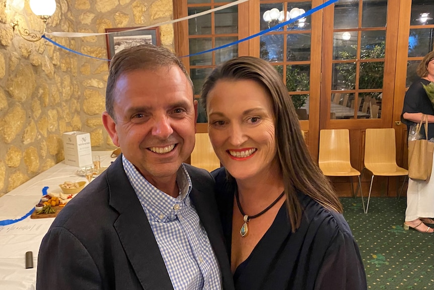 Man and woman smiling in hotel