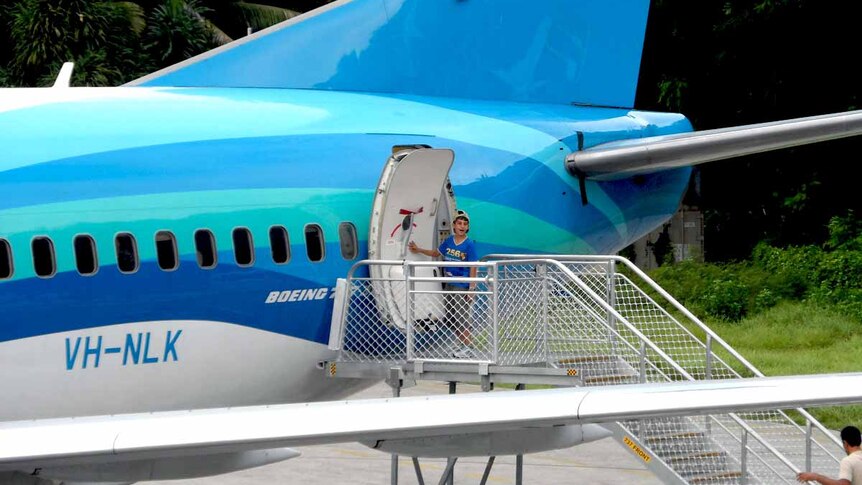 Amir boarding plane in Nauru