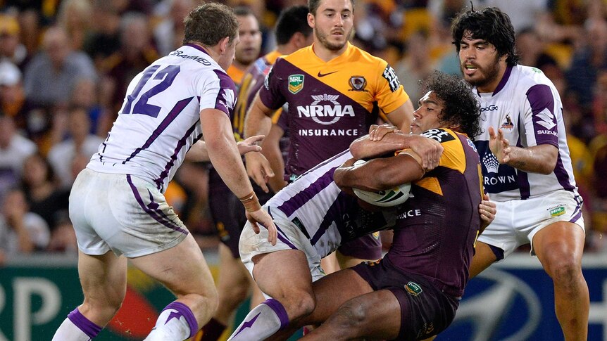 All wrapped up ... Sam Thaiday is brought down by the Storm defence