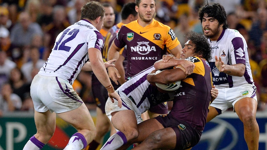 All wrapped up ... Sam Thaiday is brought down by the Storm defence