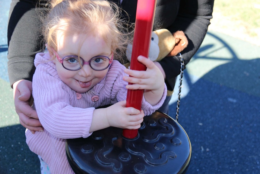 A little girl on play equipment