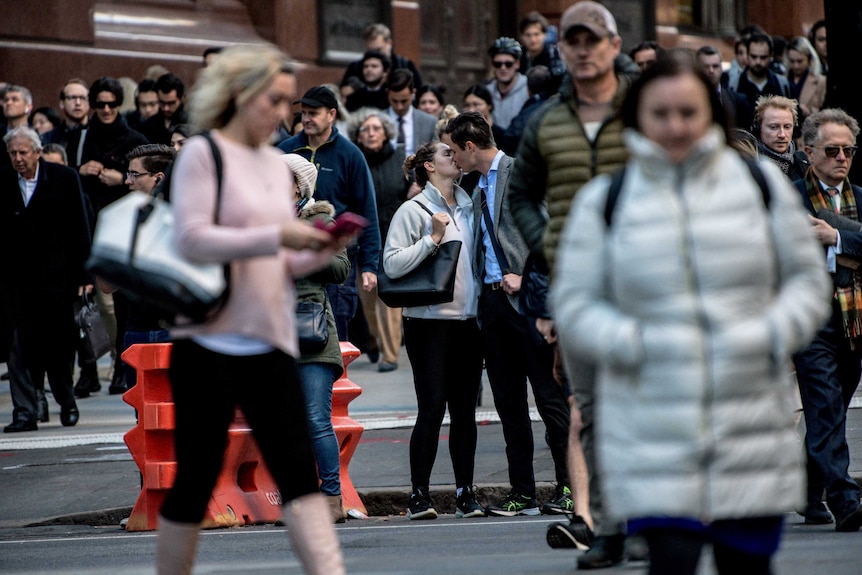 A couple kissing within the chaos.