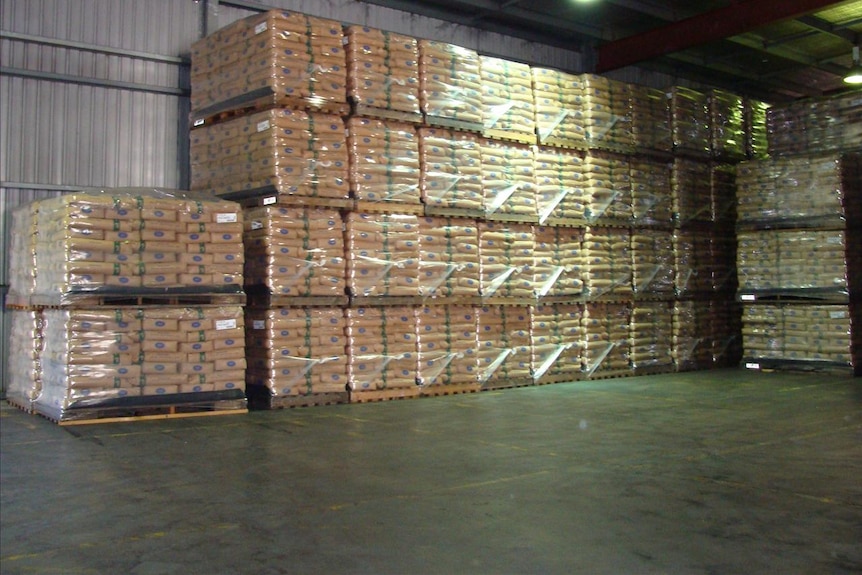 Milk powder, stacked on pallets, awaits shipping.