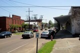 A car drives down the main street of Fayette, Mississippi