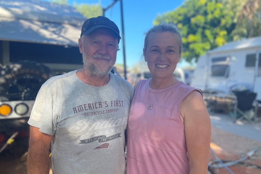 man and woman smile at camera 