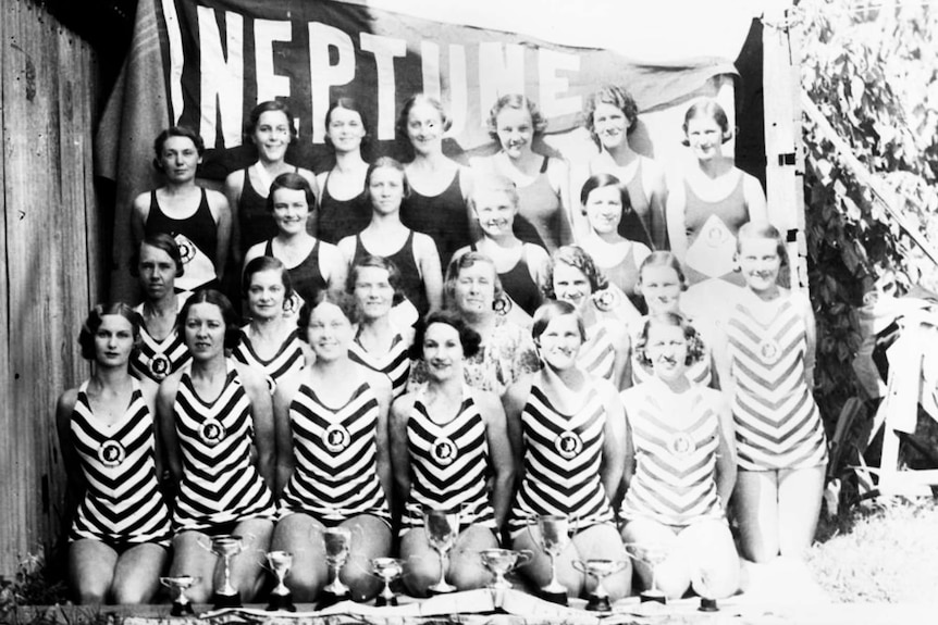 Women standing in bathing suits for a group photo in 1935.