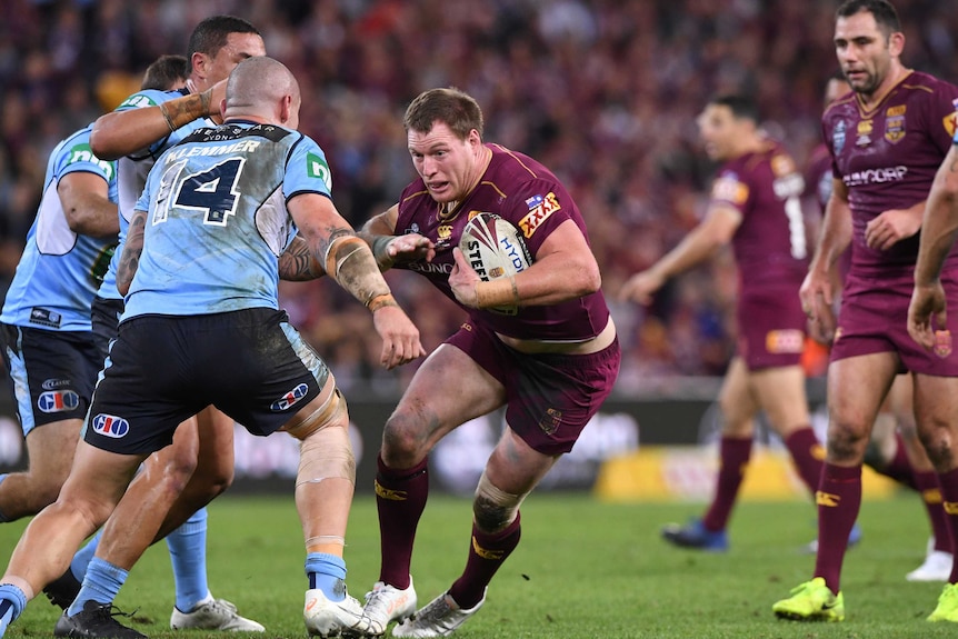 A Queensland forward runs with the ball at the NSW defence in State Of Origin