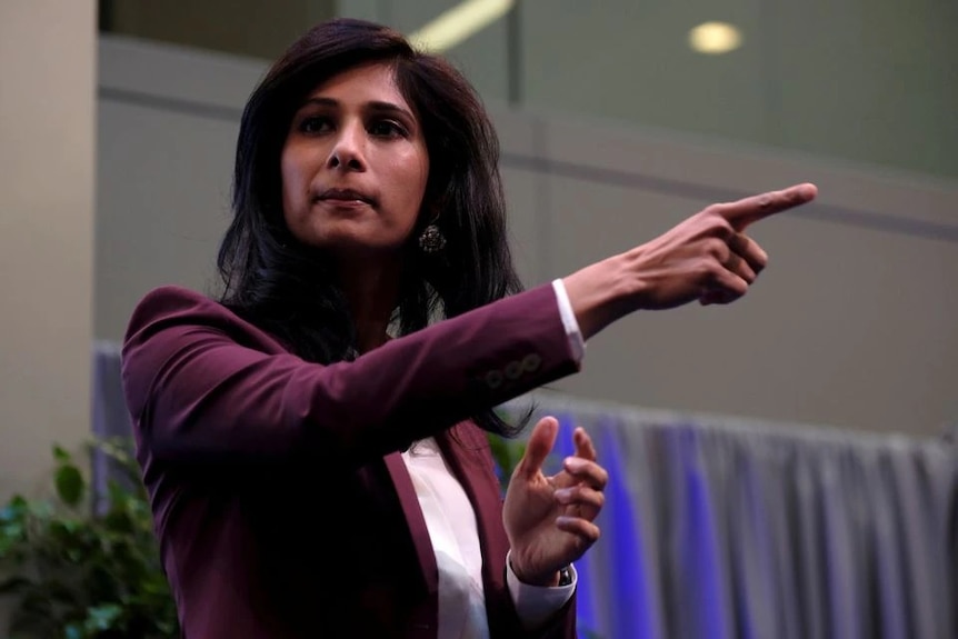 A female economist wearing a purple blazer.