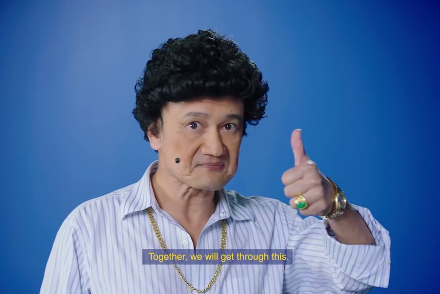 A screen grab from Singapore's vaccine ad campaign shows a man with thumbs up