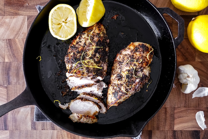 cooked chicken breast in a black skillet on a stovetop