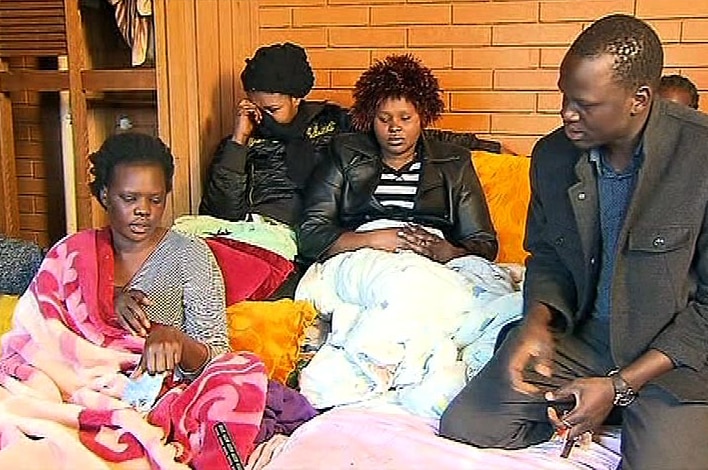 Jackline Anchito, left, the mother of Ayen Chol, is comforted at her St Albans home.
