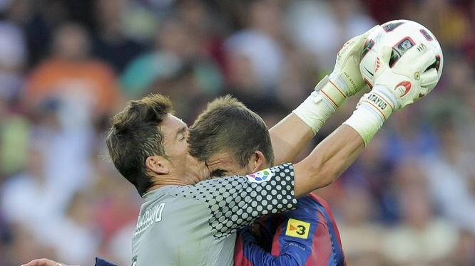 Gerard Pique required stitches after this sickening head collision with Hercules keeper Juan Calatayud.