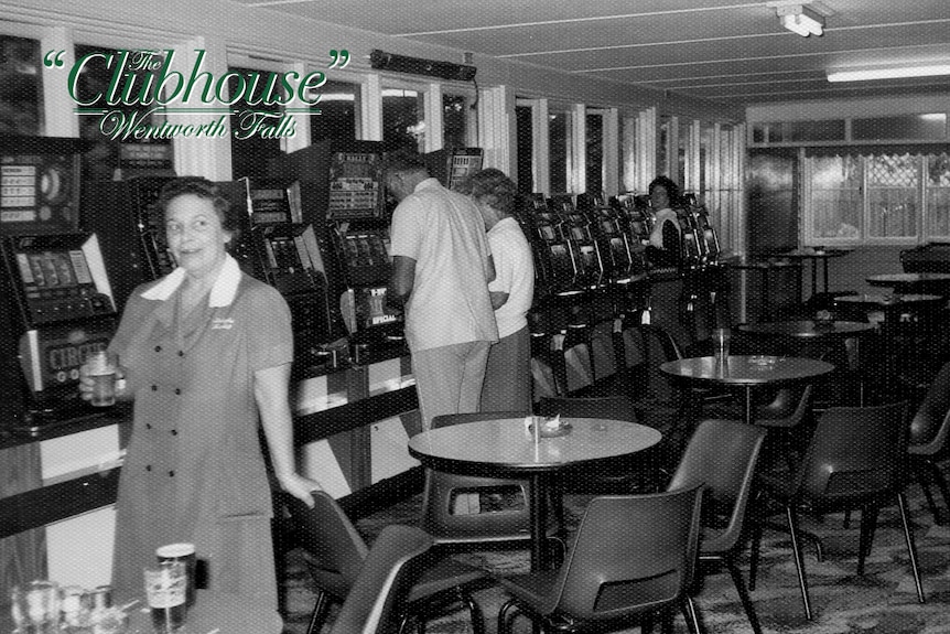 In this black and white photo, a woman poses next to a row of poker machines. 