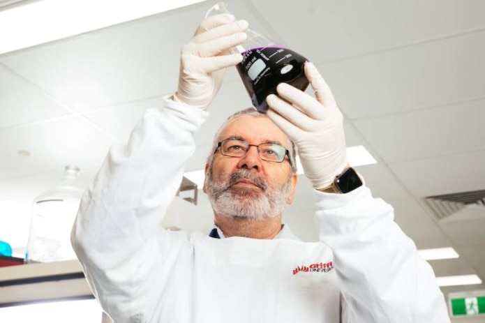 A man in a white coat in a medical laboratory