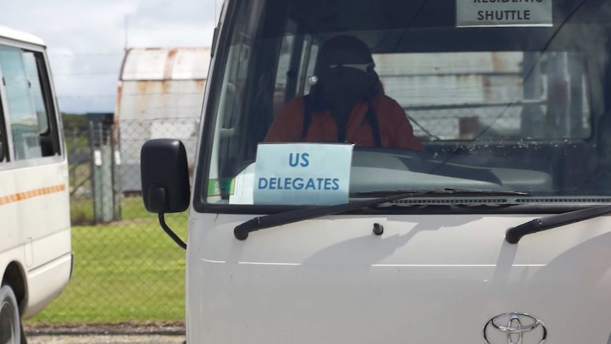 An image of a bus with a sign indicating it is for US Homeland Security staff, who have returned to Manus Island.
