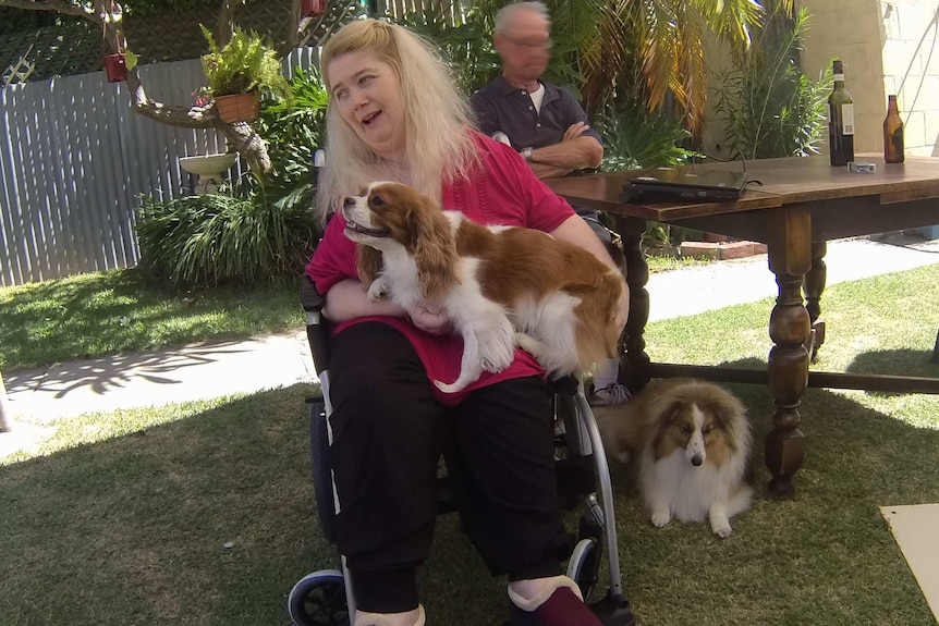 Disabled Aid Recipient Ann Marie Smith with her two dogs.