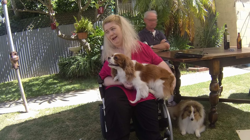 Disability care recipient Ann Marie Smith with her two dogs.
