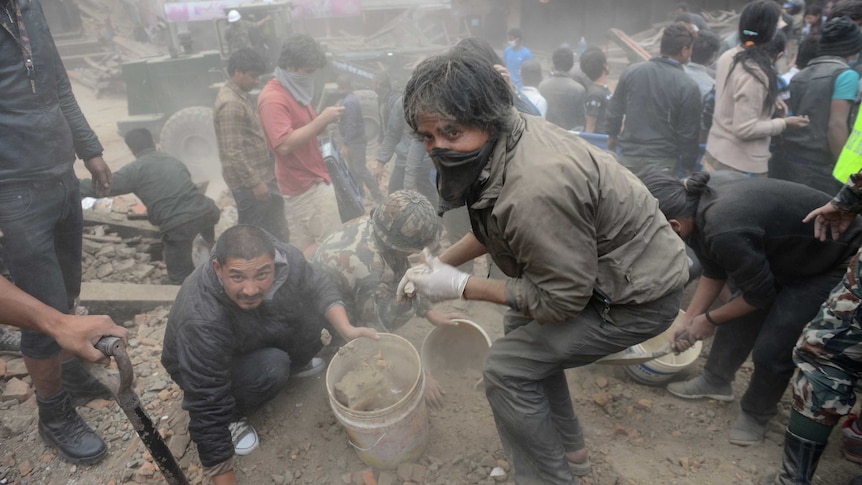 People clear rubble in Kathmandu's Durbar Square