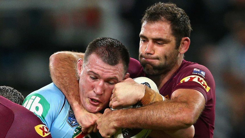 All wrapped up ... Blues captain Paul Gallen is tackled by his Maroons counterpart Cameron Smith