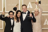 Ke Huy Quan, Michelle Yeoh, Brendan Fraser and Jamie Lee Curtis all holding oscars