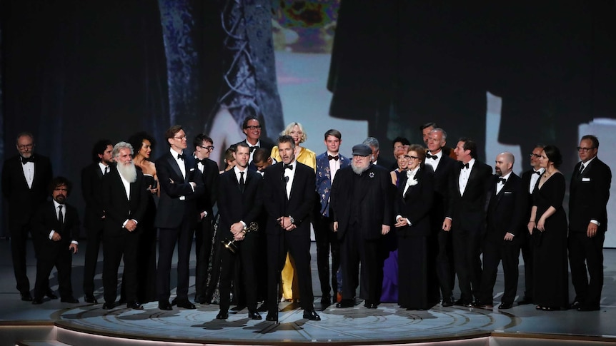 The cast of Game of Thrones accept their Emmy Award on stage