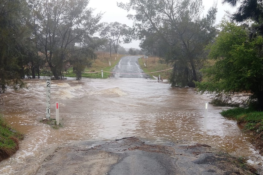 Heavy flooding across a sealed road