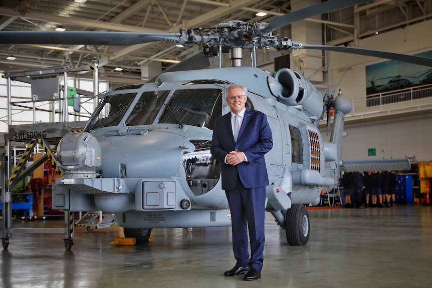 Scott Morrison standing in front of a seahawk helicopter