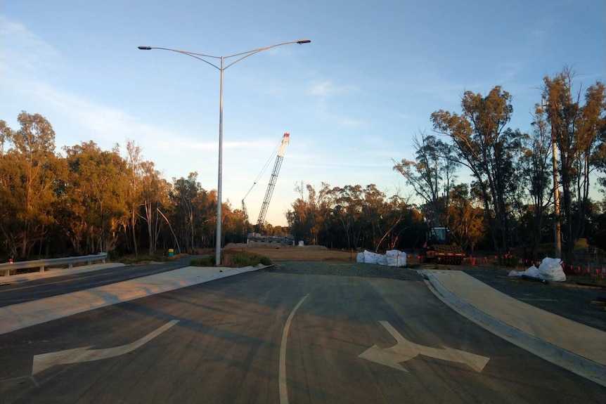 It is early morning, construction of the Campaspe Bridge is in the foreground and background.