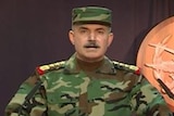 A Syrian army general stands at a podium on state television to declare victory in Aleppo.