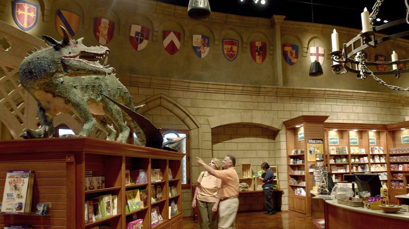 Visitors watch exhibits at the new Creation Museum where among other things dinosaurs sail on Noah's Ark.