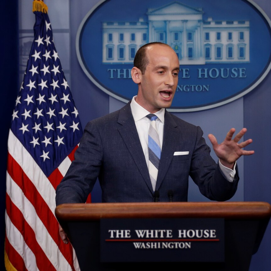 Stephen Miller gestures with his hand as he speaks at a White House press conference.