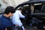 Abdullah al-Raghie (CL) and Abdul Moheman al-Raghie (L), the sons of al-Qaeda suspect Abu Anas al-Libi, show members of the press their father's car from which he was taken by US special forces in a commando raid in Nofliene, five kilometres from the Libyan capital Tripoli on October 6, 2013, sealing a 15-year manhunt for him. Libya said it had demanded an explanation from Washington for the "kidnap".