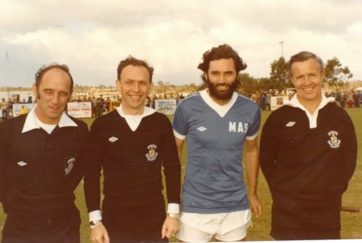 George Best standing with referee Frank Green and officials.