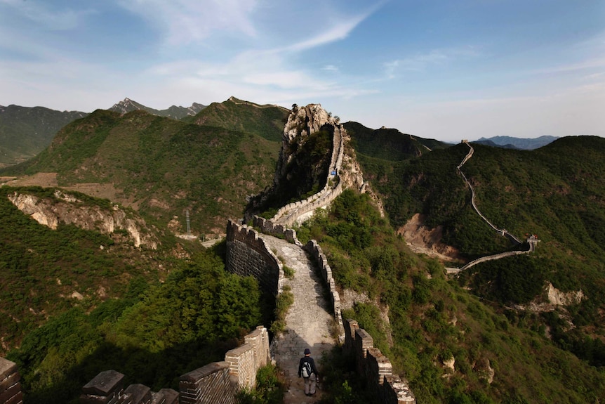 A visitor walks on the Luanling section of the Great Wall of China