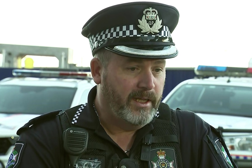 Queensland police officer Inspector Andrew Tracey speaking to media while in uniform