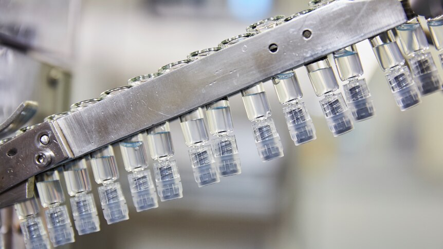 Vials of vaccines on a manufacturing floor.