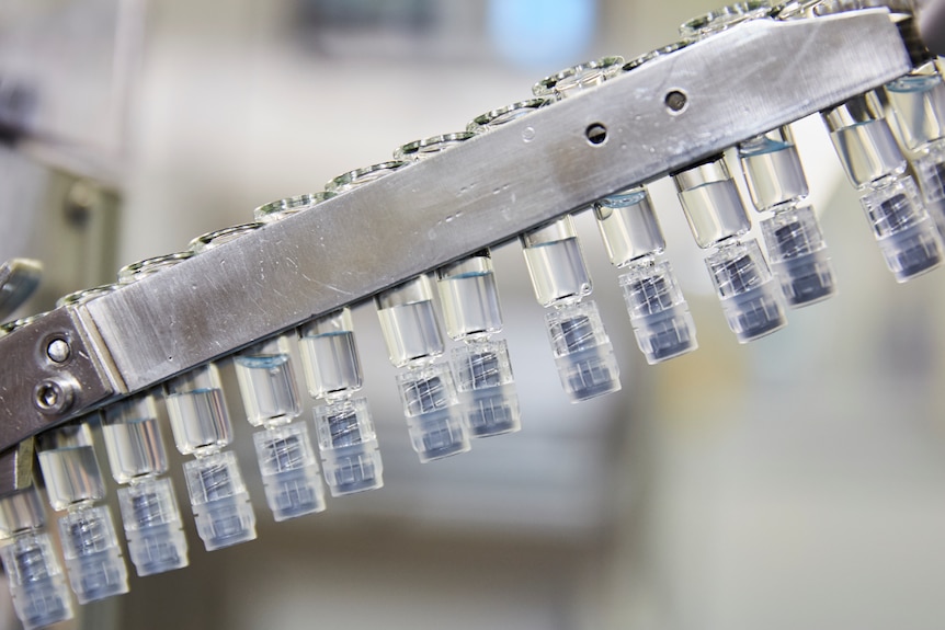 Vials of vaccines on a manufacturing floor.
