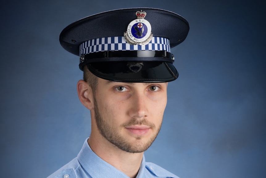 A young policeman in uniform in an official portrait